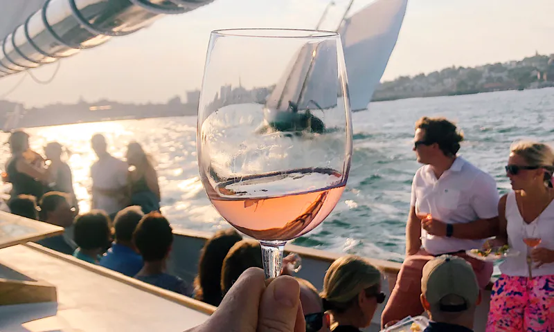 A glass of wine on a sailboat.